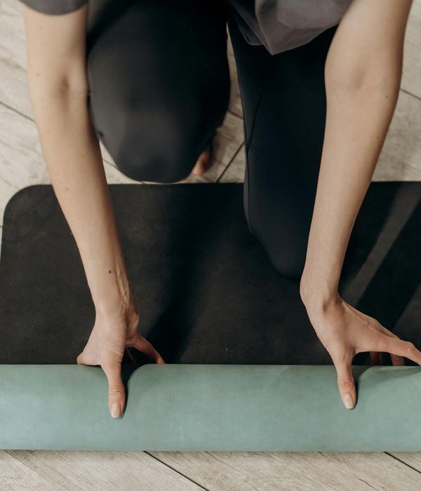 Close-up of a yoga mat corner in a softly lit room.